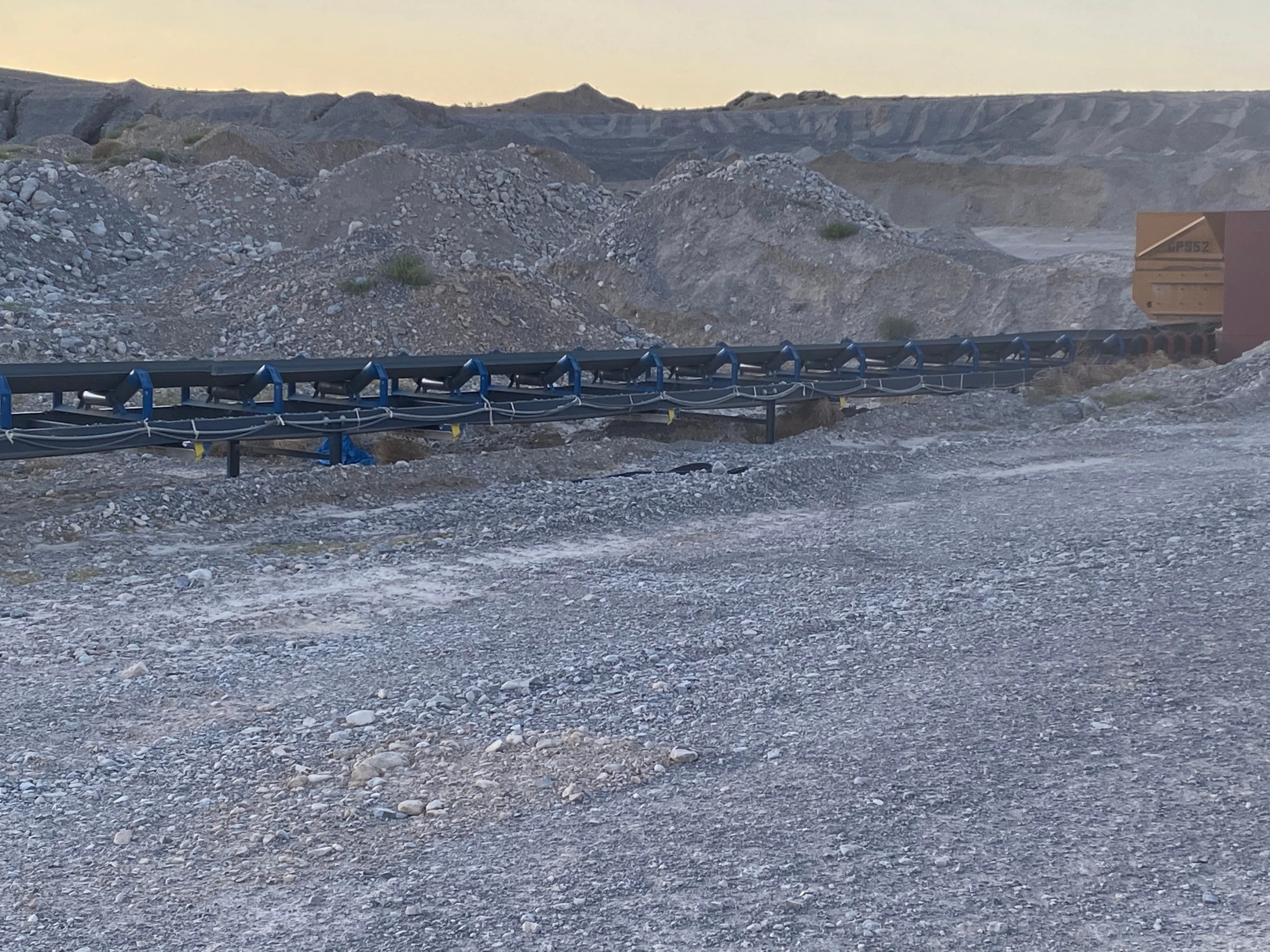 Apache overland conveyor structure with a mining haul truck in the background